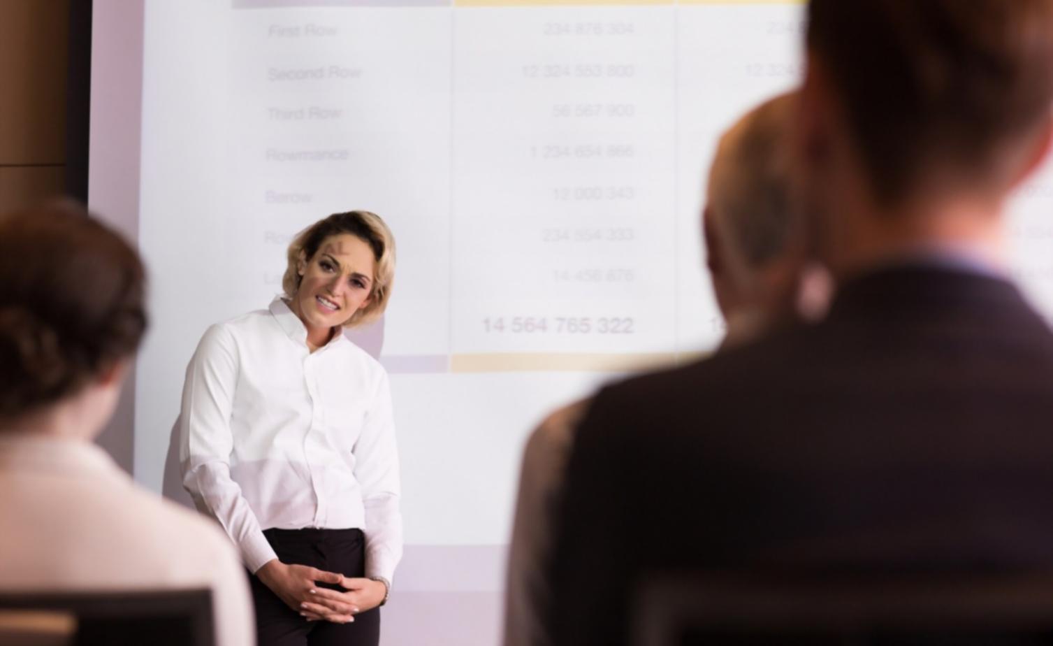Student analyzing stock market charts and financial data on multiple screens